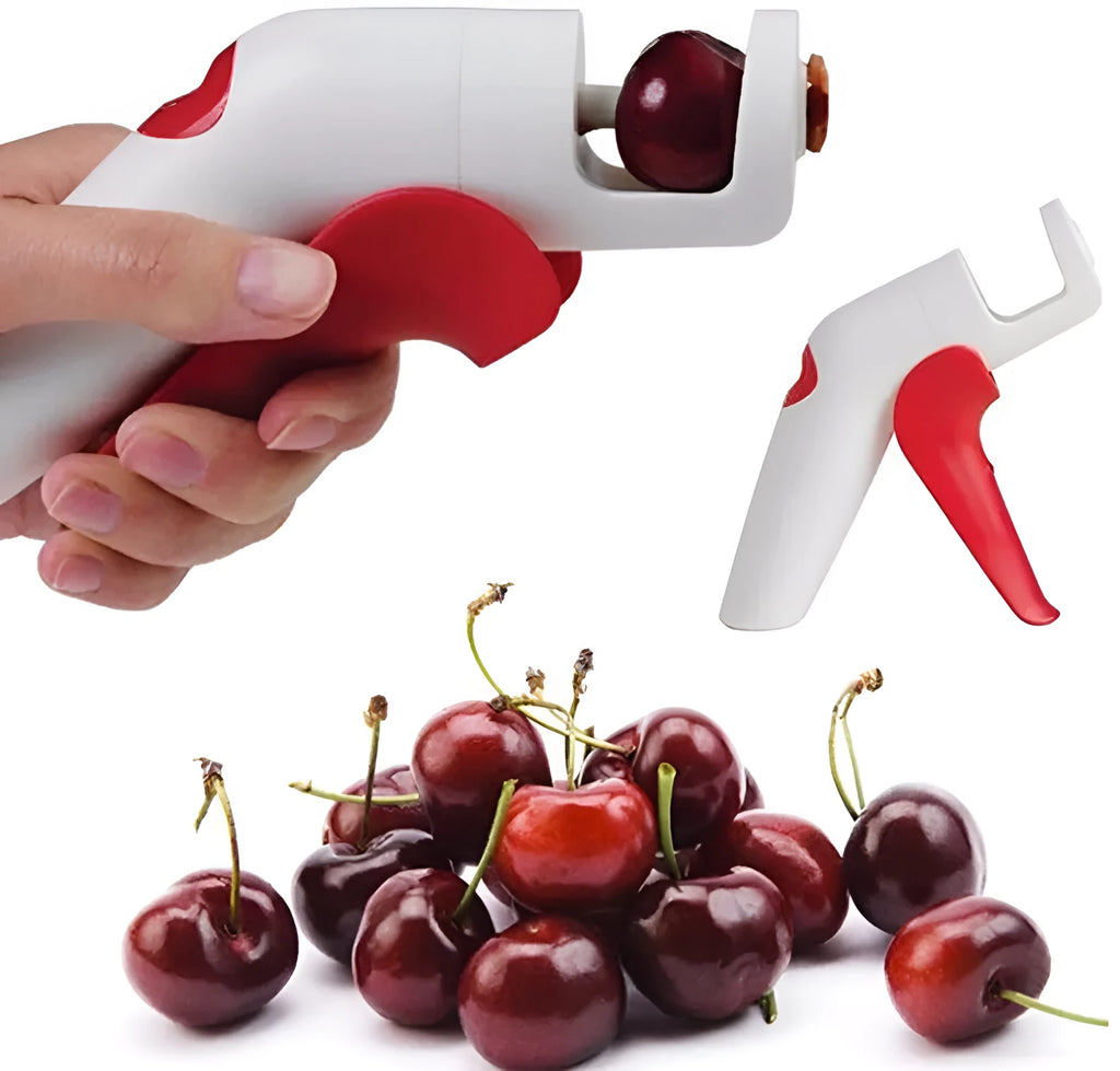 Red and white stainless steel manual cherry kernel remover pitter on a clean surface