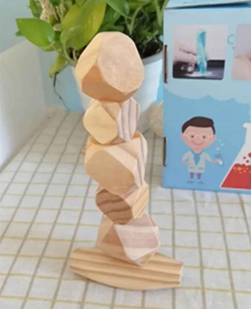 Wooden building block set with coloured and natural stone stacks on a table, suitable for children aged 4-6