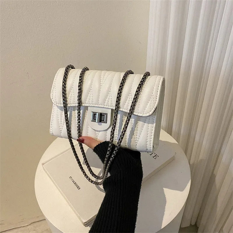 Retro textured diamond pattern women's small handbag in a choice of colours showing front view and internal phone pocket.