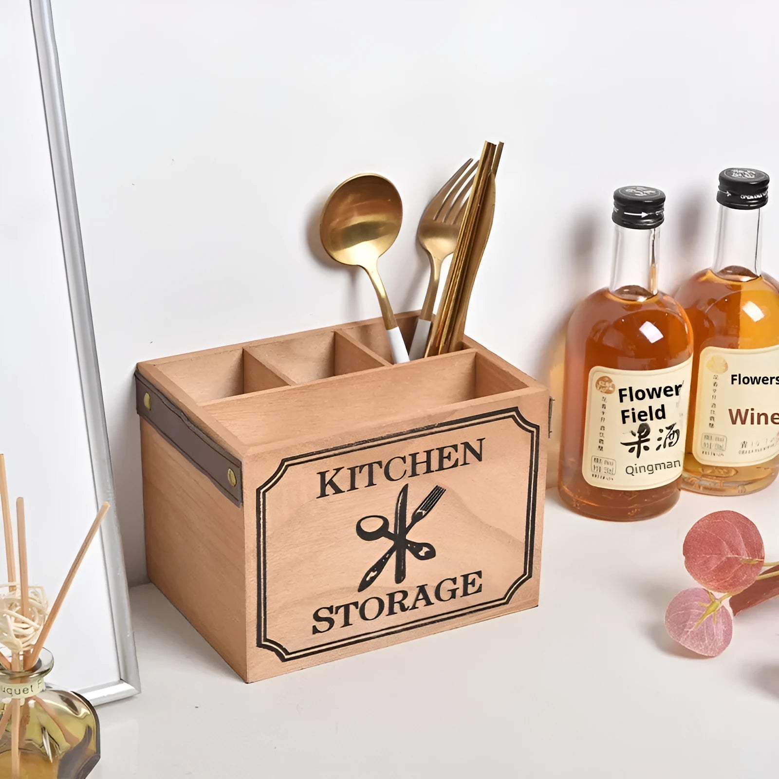 Open wooden kitchen storage box with grid divider for knives, forks, and chopsticks.