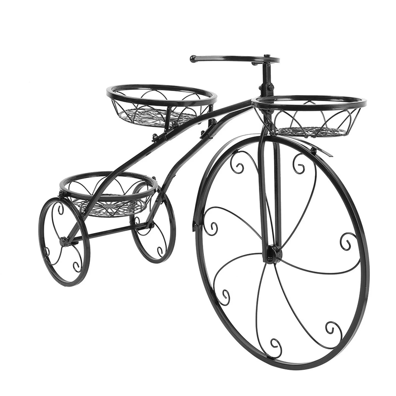 Black wrought iron tricycle plant stand with three round baskets holding small potted plants on a patio