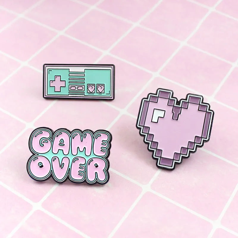 Stereo game console metal alloy badge with pin back, shown in available colours on a backpack strap