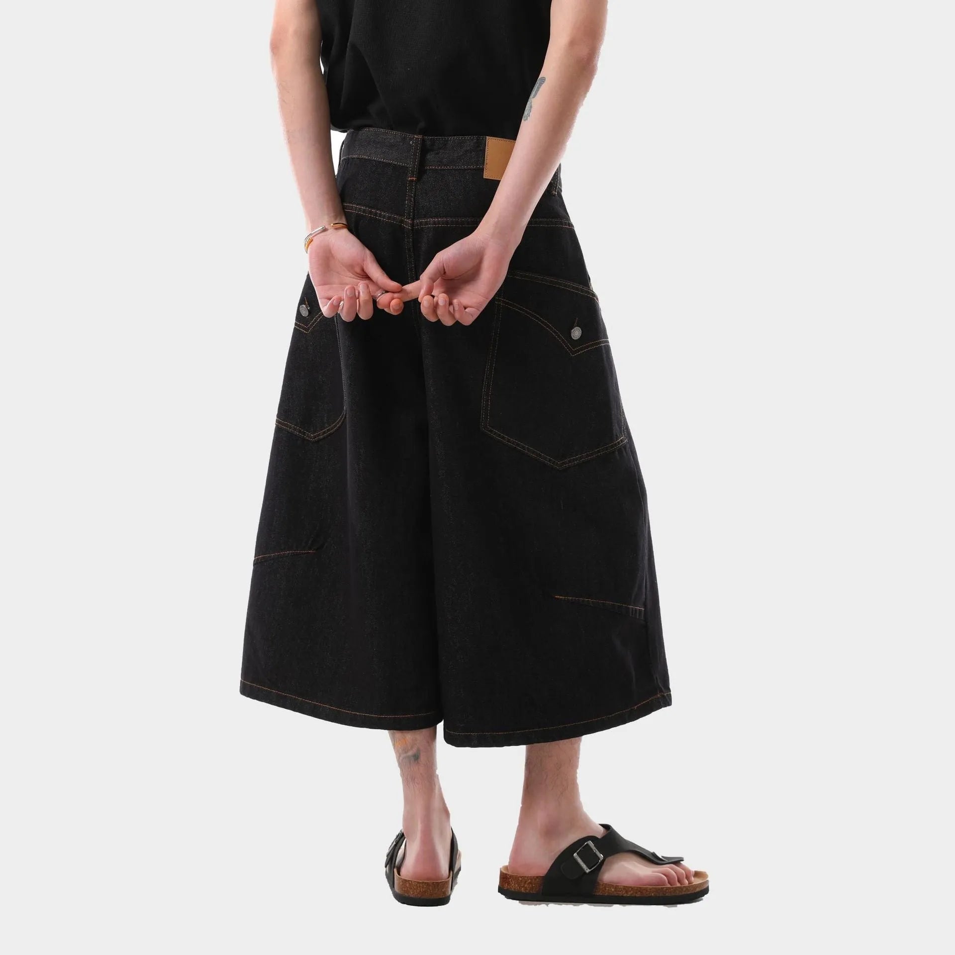 Man wearing black retro washed straight-leg denim cropped pants with side pockets.