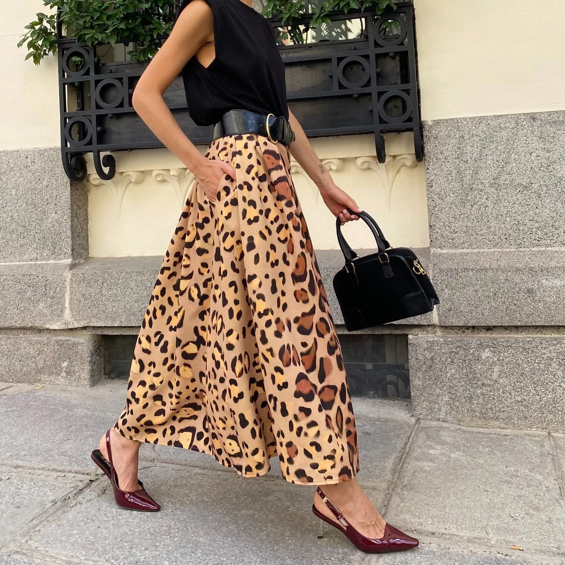 Brown leopard print women's long A-line skirt with a big hem, laid flat.