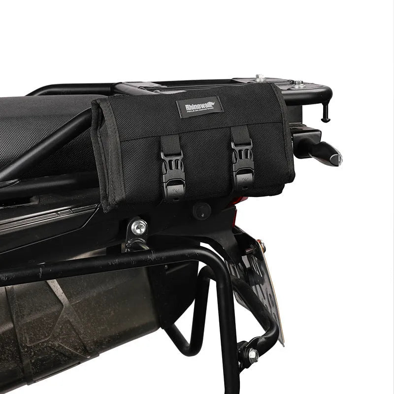 Motorcycle repair tool roll laid flat in black polyester with elastic straps and mesh zipper pocket