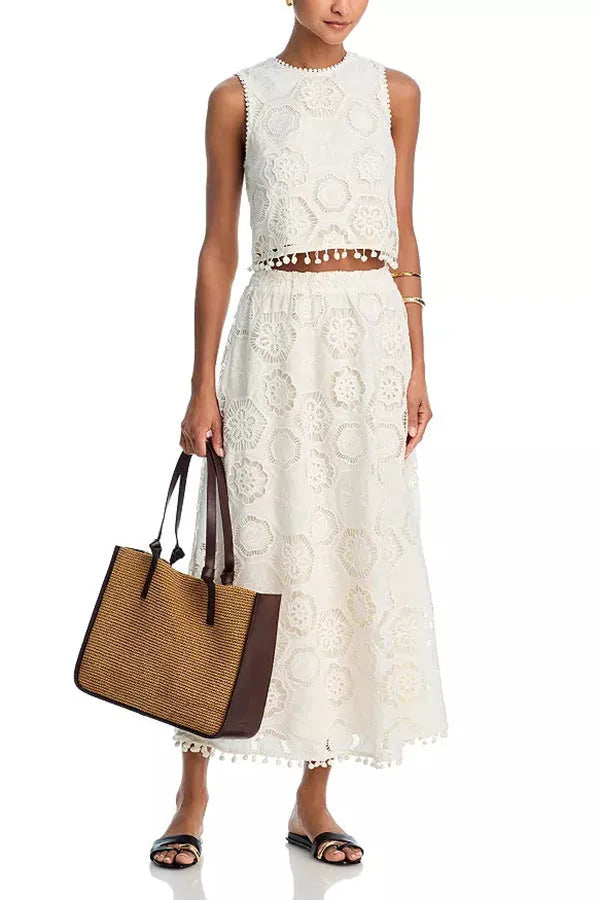 White women's two-piece suit with sleeveless top, long embroidered skirt, retro style.