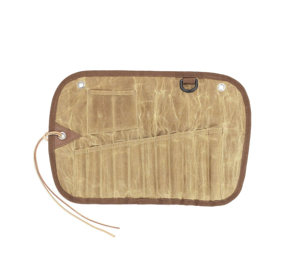 Green waxed canvas tableware storage bag containing wooden handle knives, forks, spoons, and chopsticks for outdoor use.