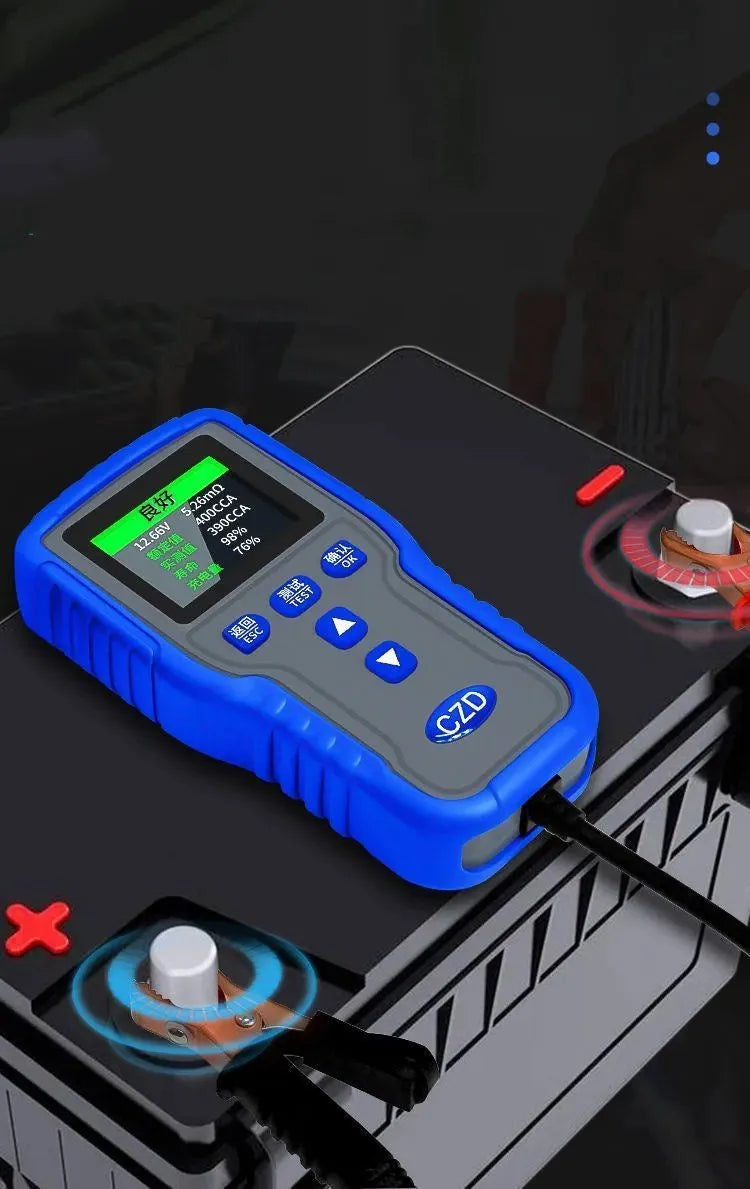 TKM016 car battery tester on a workbench, showing its compact 167x86x32mm size and handheld design