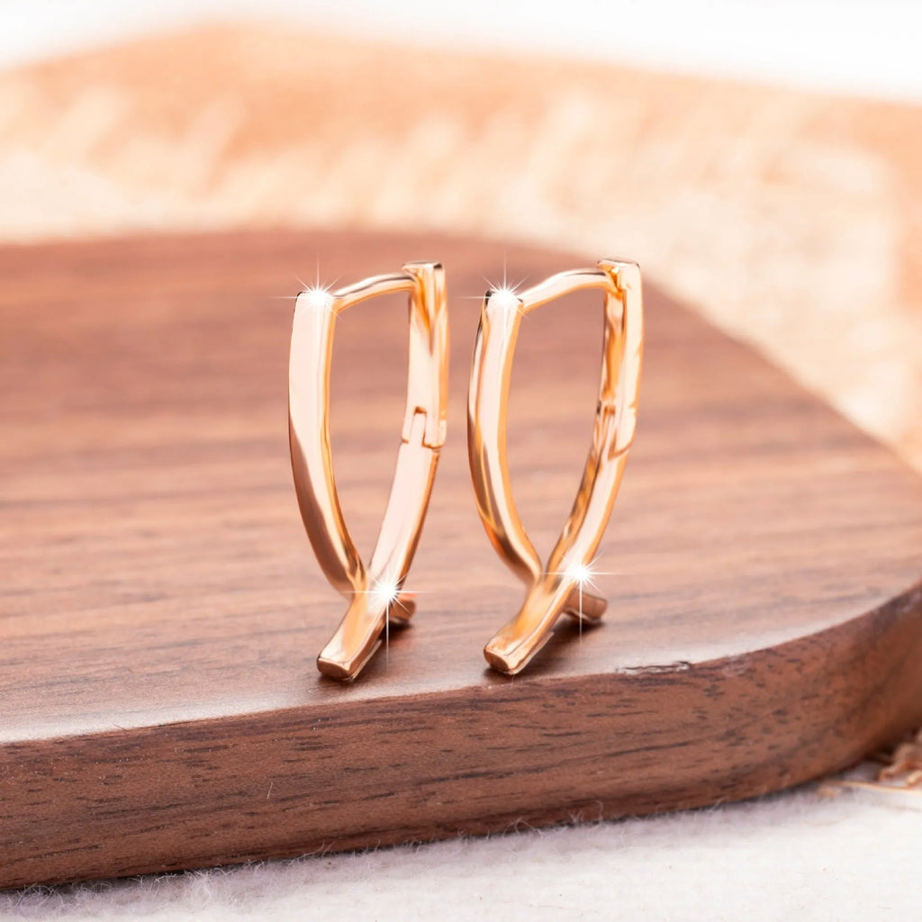 Rose gold copper cross shaped earrings with light luxury aesthetic