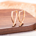 Rose gold copper cross shaped earrings with light luxury aesthetic
