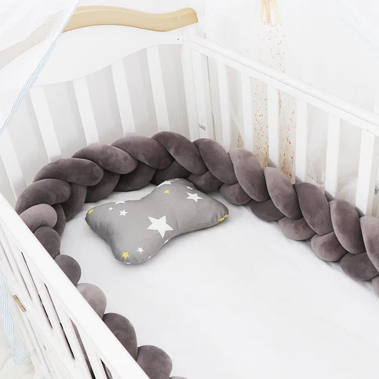 Baby cot bumper braid in spandex crystal velvet, shown in a light grey colour, wrapped around white crib rails.