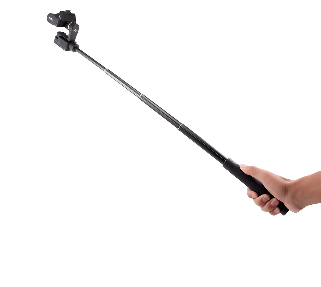Black retractable aluminium selfie stick extended with phone attached, showing Bluetooth remote and tripod stand.