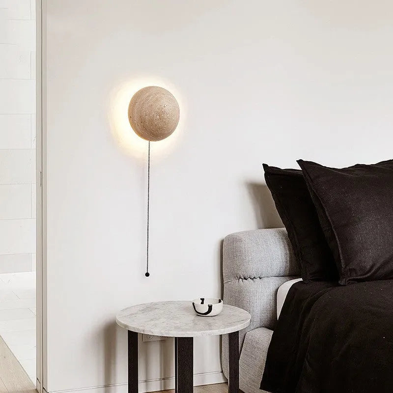 Yellow semicircle cave stone wall lamp with wooden fixture mounted on a wall.