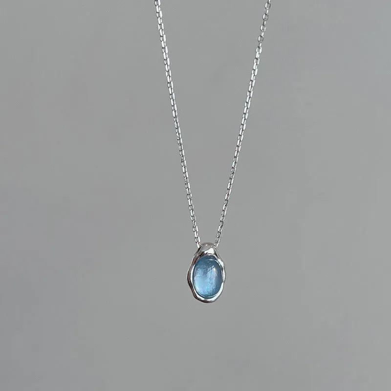Women's navy blue geometric water drop pendant necklace on an adjustable copper chain.