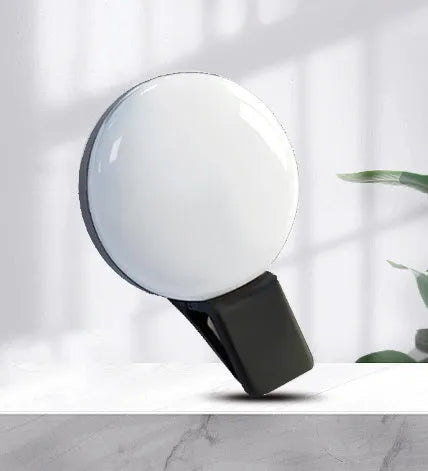 Circular mobile phone selfie ring light attached to smartphone providing frontal illumination