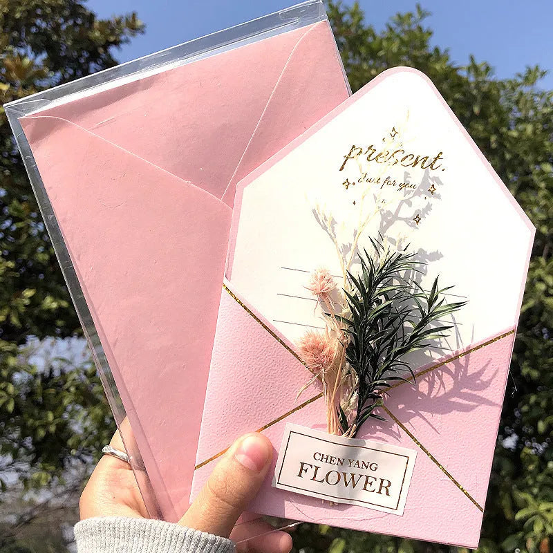 Handmade 3D butterfly-shaped greeting card with artificial flowers in a box, alongside its matching envelope.