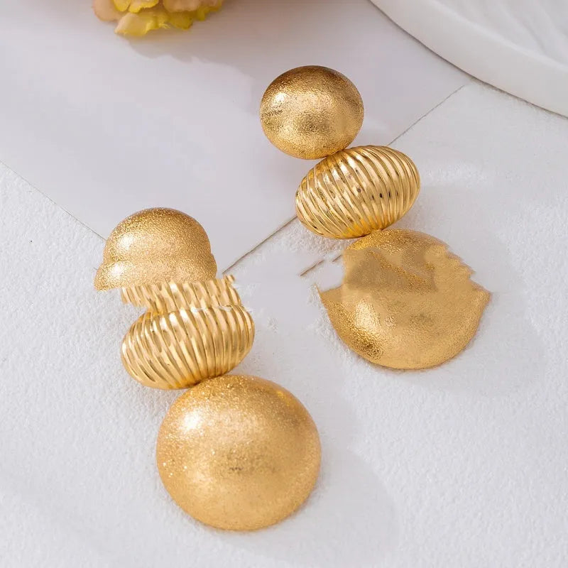 Retro women's polka dot metal bead drop earrings in frosted gold finish on a neutral background