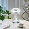 Small white rechargeable table lamp with USB cable and three colour light settings.