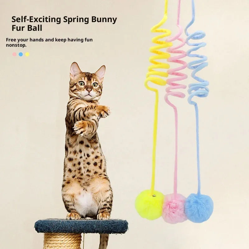 Blue cat toy with suction cup, spring rabbit fur ball, and retractable elastic rope on a door surface