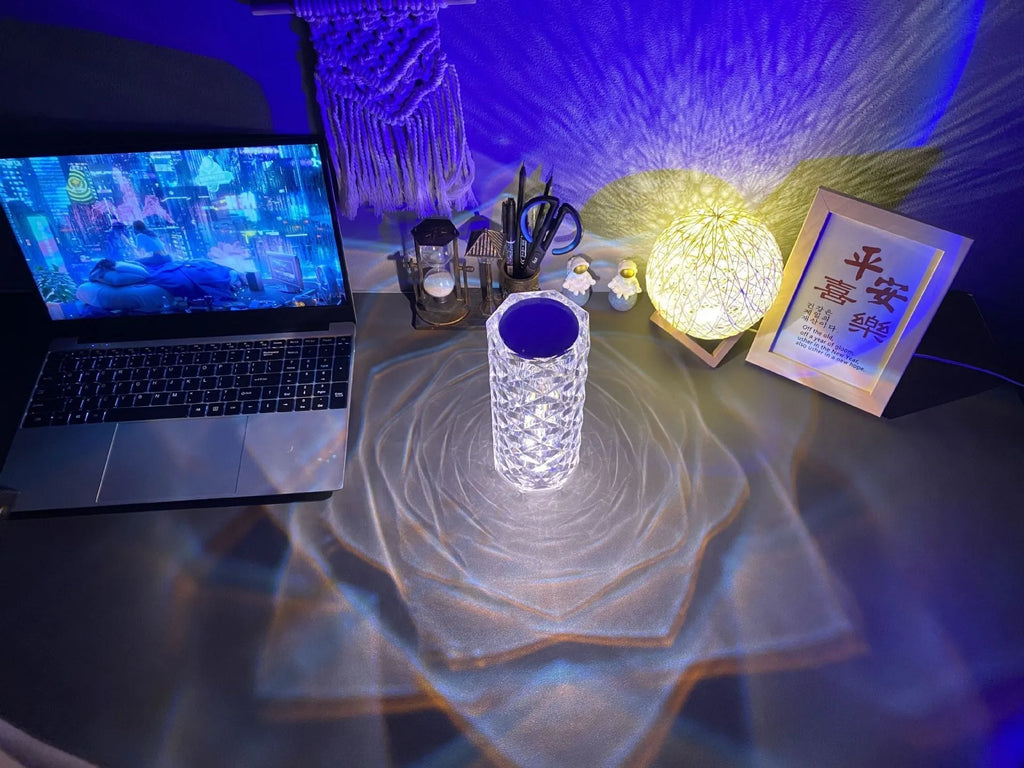 Modern acrylic rose LED table lamp with diamond base and touch control on wooden surface