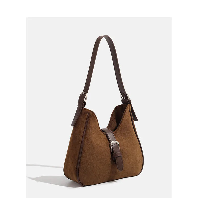 Retro suede leather underarm shoulder bag in brown with double connector straps on a white background