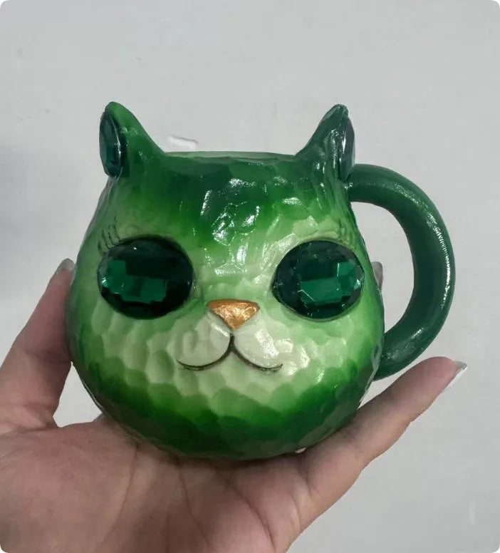 Resin cat cup crystal globe decorative ornament on a desk, shown in purple colour.