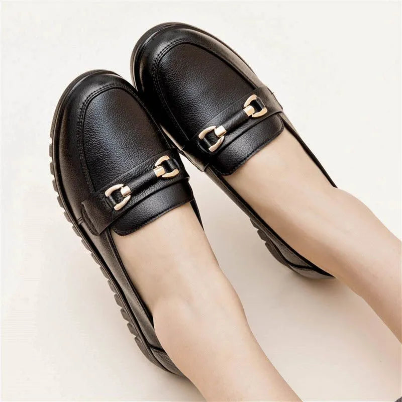 Black soft-leather casual pumps with round toe, low flat heel, and rubber sole.