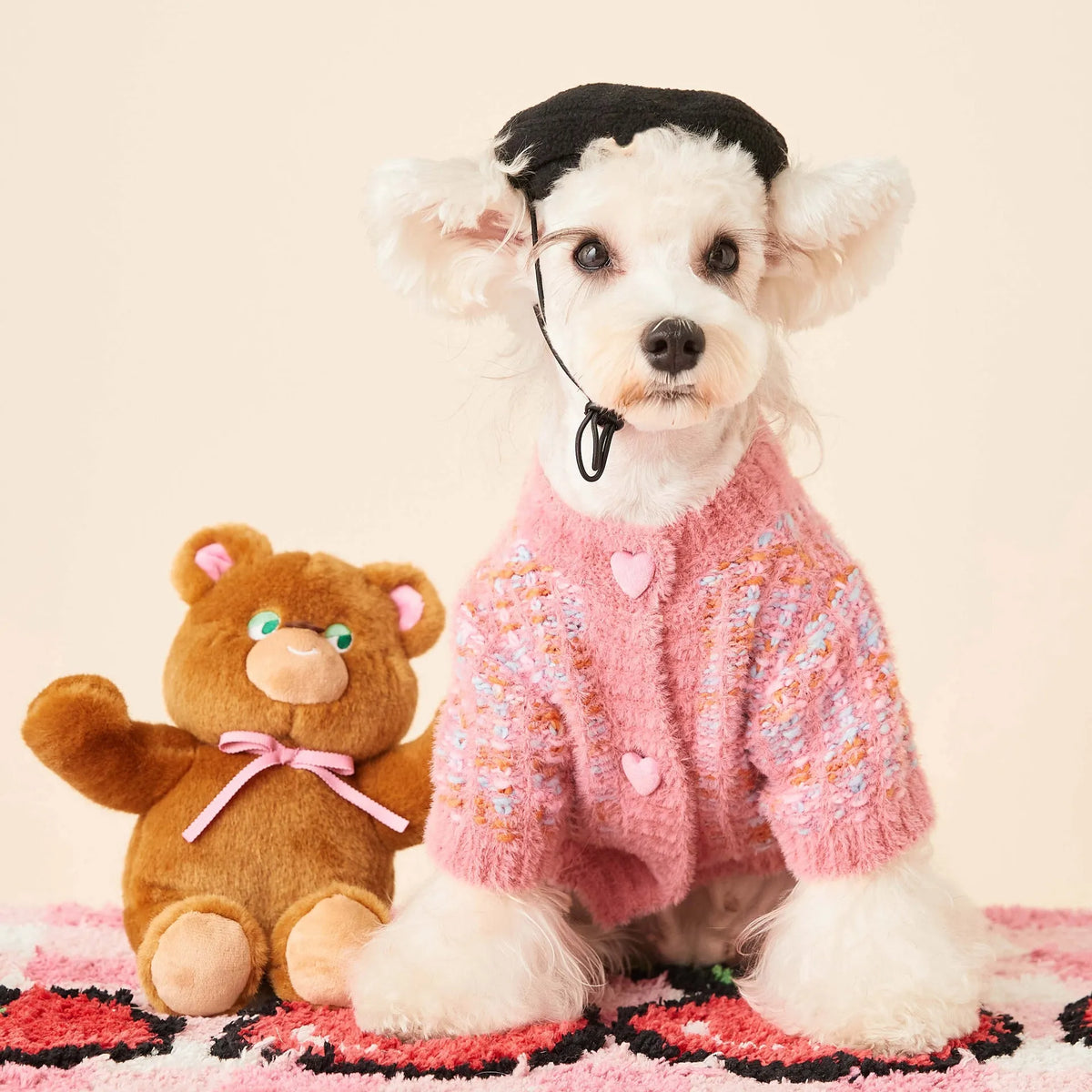 Female dog wearing a colourized wool pet cardigan in pink with a vest-style fit, side view