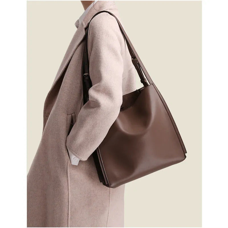 Brown genuine leather women's retro bucket bag with double shoulder straps showing interior organisation compartments
