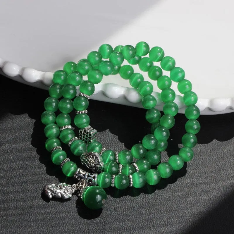 Opal crystal cat eye bracelet with lucky cat charm, shown in one of six colour options.