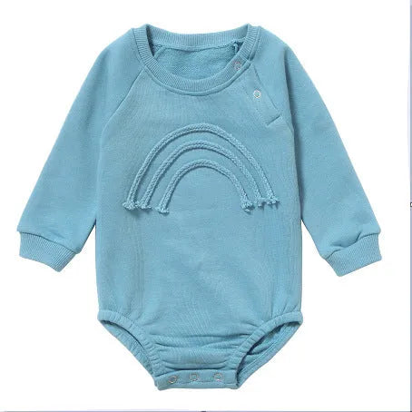 Long-sleeved waffle cotton baby romper in a neutral colour on a hanger, showing the triangular climbing front closure.