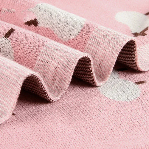 Soft pink baby blanket cover for a sheepskin, laid flat showing its rectangular 100cm by 80cm size.