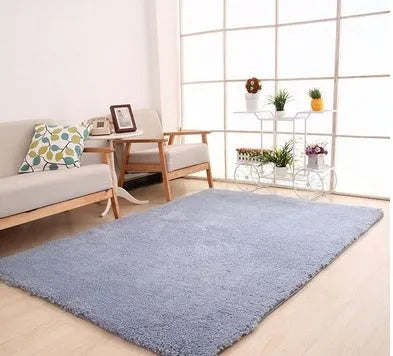 Solid colour plush carpet with soft surface and rectangular shape on hardwood floor
