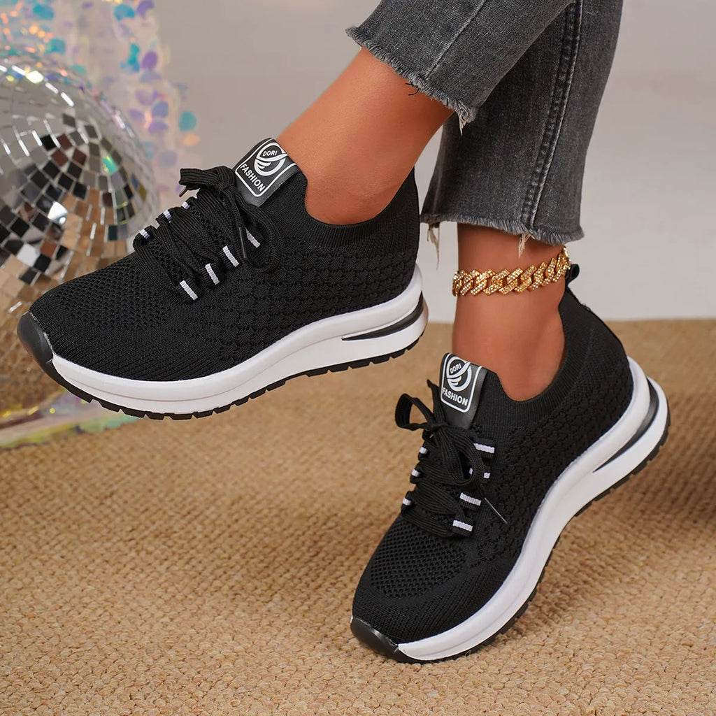 Women's black mesh lace-up flat pumps with round toe and rubber sole on white background