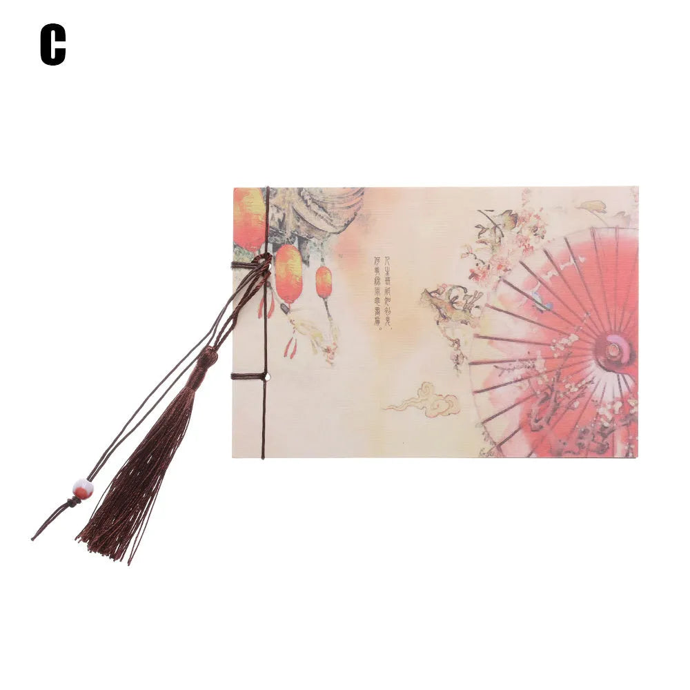 Hand-stitched kraft paper notebook with tassel bookmark on blank pages.