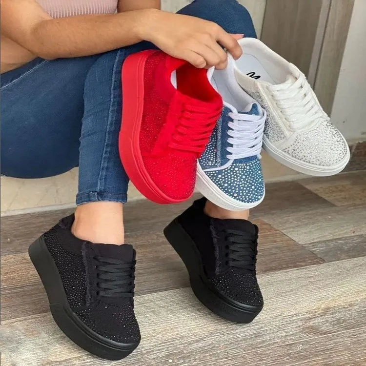 Women's black casual sports shoes with lace-up front, rhinestone detail, and thick rubber sole.