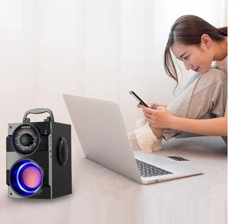 Black portable mini home audio system with subwoofer and 3.5mm audio connection cable
