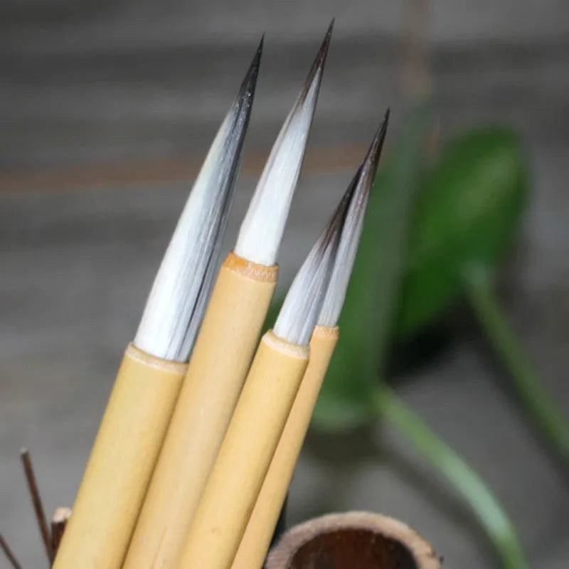 Set of four gold-coloured calligraphy brushes with wolf wool thread and mixed hair tips.
