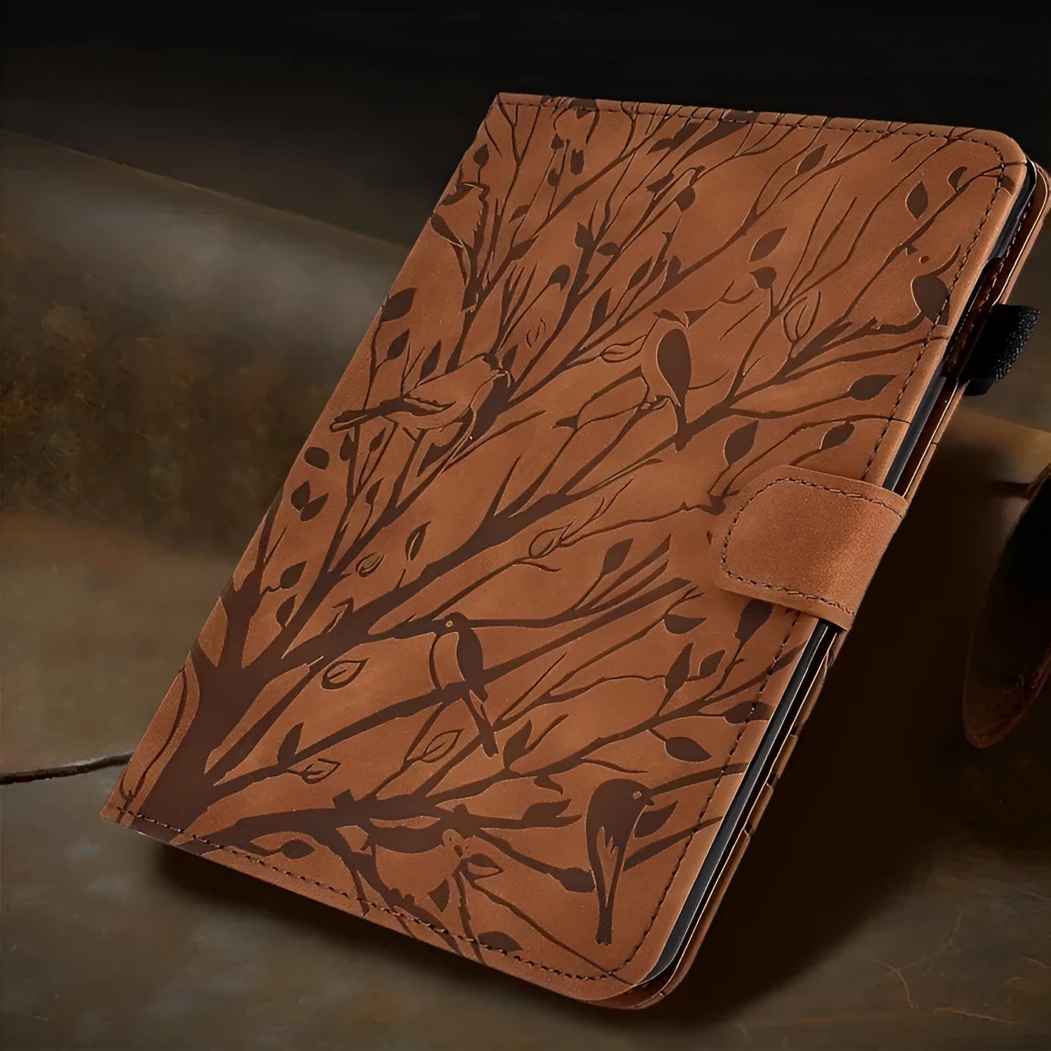 Imitation leather tablet protective case in khaki colour with an engraved texture and built-in stand, open to show an iPad.