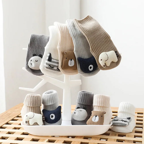 Baby socks with non-slip rubber grip soles on the feet, shown in a light grey colour.