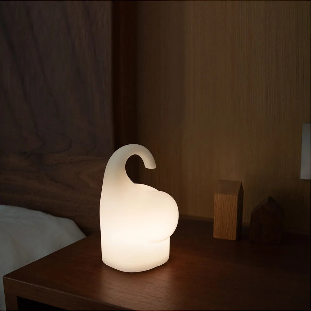 DOMI Elephant style silicone and plastic LED night light with warm white glow on a bedside table.