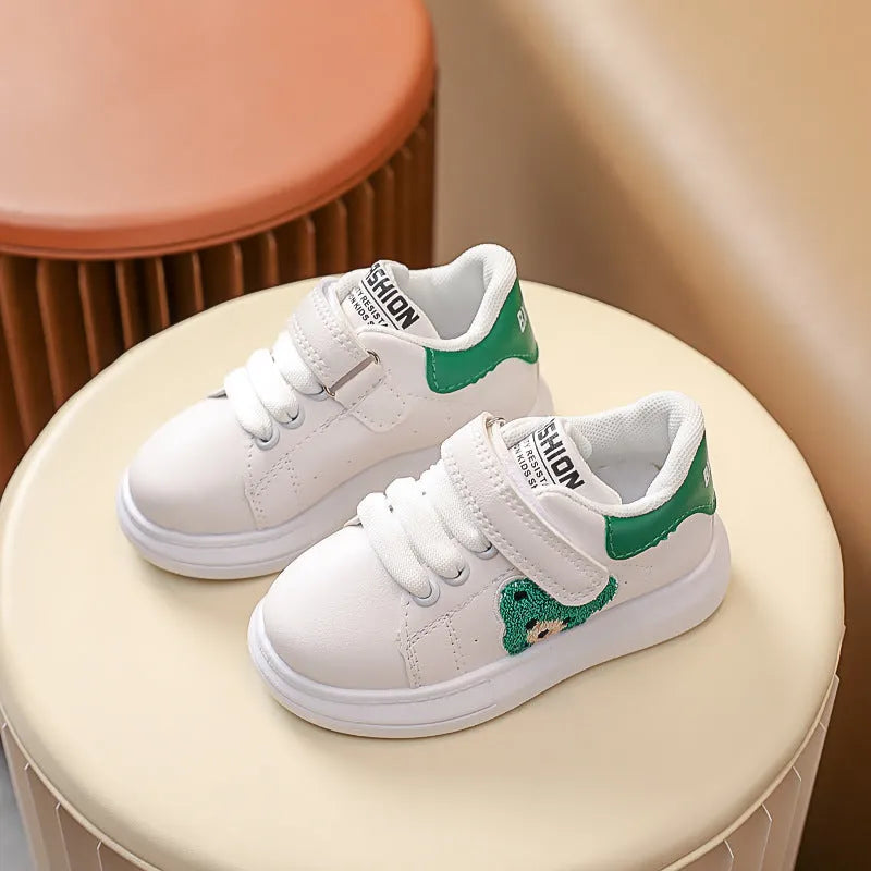 Children's black cartoon bear casual sports shoes with artificial leather upper and rubber sole.