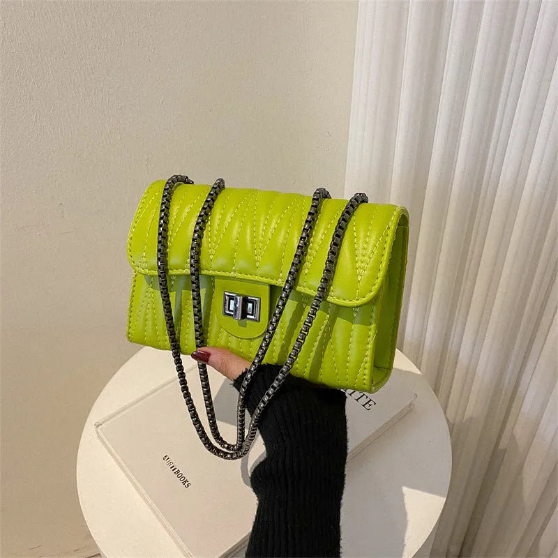 Retro textured diamond pattern women's small handbag in a choice of colours showing front view and internal phone pocket.