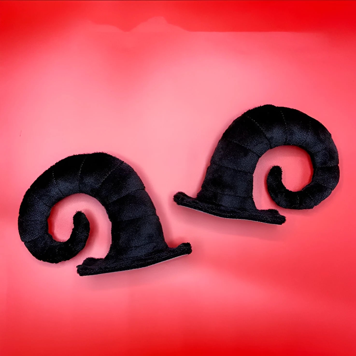 A pair of composite fibre demon horn ornaments for a motorcycle helmet in a chosen colour.