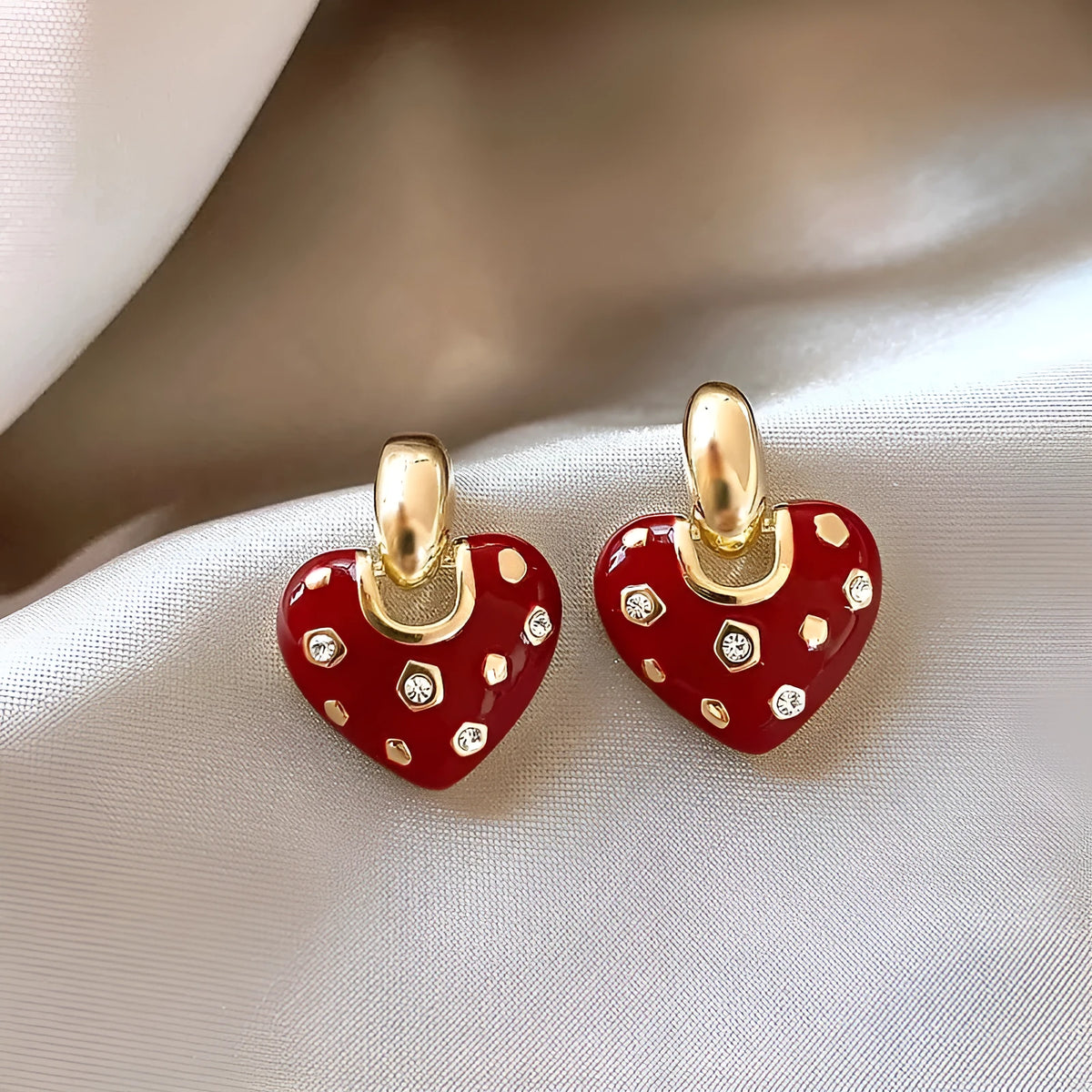 Pair of red heart-shaped ear studs in zinc alloy with electroplated finish
