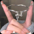 Silver adjustable girlfriends bracelet with bow-shaped bell opening clasp