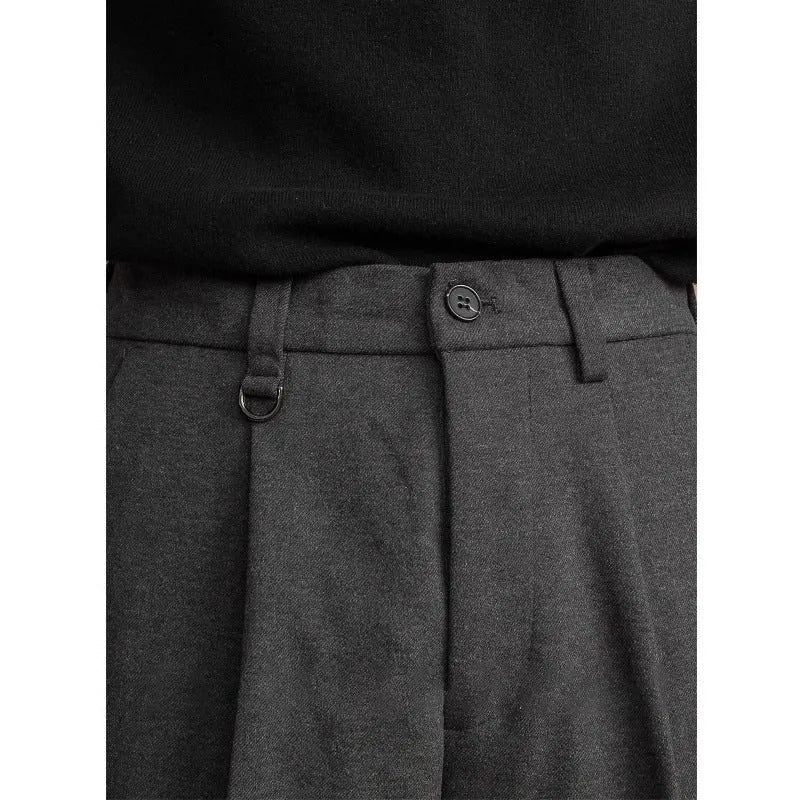 Men's straight-leg casual trousers in draped design, shown in a neutral colour on a hanger.
