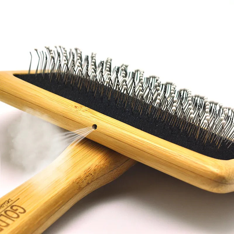 Pet grooming bamboo wood air cushion needle comb with original bamboo colour handle and steel pins on a clean background