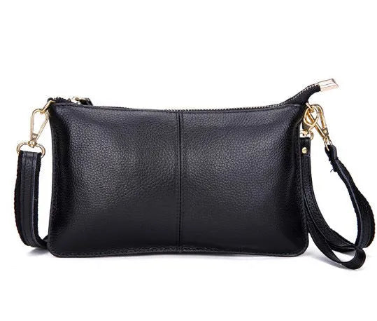 Lady's cowhide leather slant bag in apricot colour with hand strap and shoulder strap showing zipper compartments