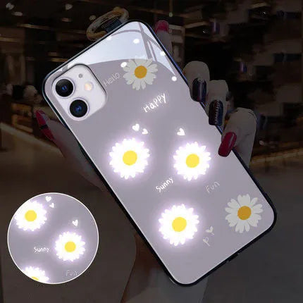 White luminous iPhone case with painted purple daisy design and voice-activated colour light.